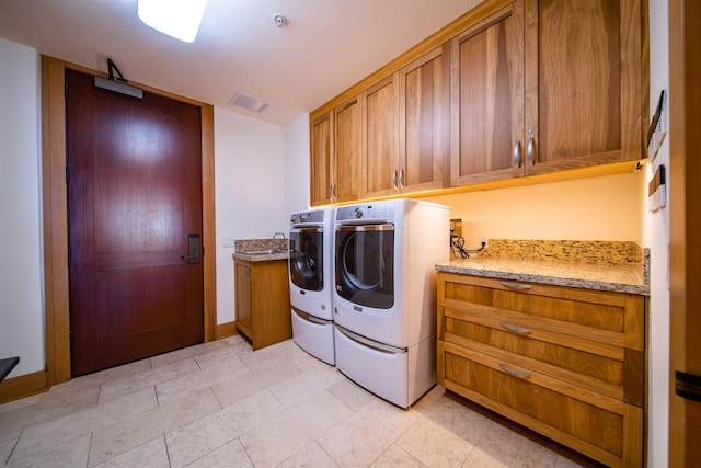 laundry area featuring cabinets and washer and dryer