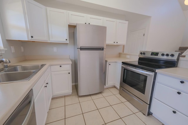 40 Halili Ln Unit 4J, Kihei, HI 96753 - kitchen with appliances with stainless steel finishes, a sink, white cabinetry, light countertops, and light tile patterned floors