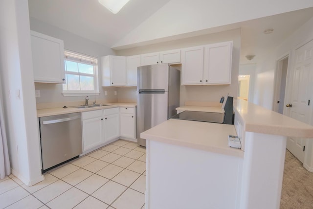40 Halili Ln Unit 4J, Kihei, HI 96753 - kitchen featuring appliances with stainless steel finishes, a sink, white cabinetry, washer / clothes dryer, and vaulted ceiling