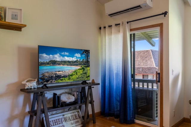 2050 Kanoe St Unit 208, Kihei, HI 96753 - doorway to outside with a wall mounted air conditioner, wood finished floors, and baseboards