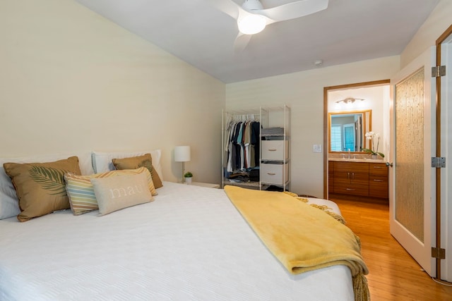 2050 Kanoe St Unit 208, Kihei, HI 96753 - bedroom featuring light wood-type flooring, a closet, ceiling fan, ensuite bath, and a sink