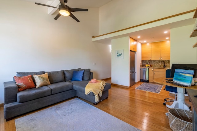 2050 Kanoe St Unit 208, Kihei, HI 96753 - living area featuring light wood finished floors, a ceiling fan, a high ceiling, baseboards, and recessed lighting