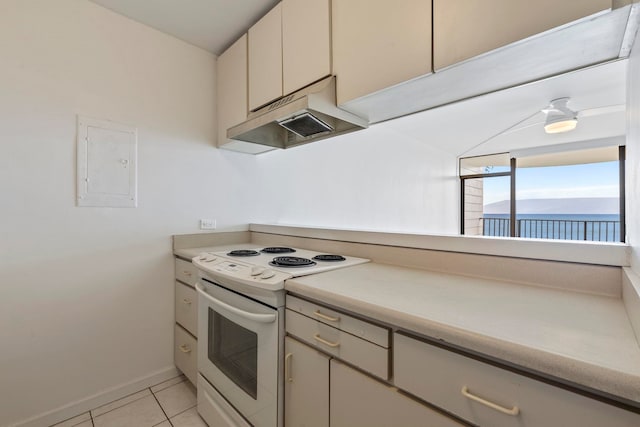 kitchen featuring electric panel, light countertops, white electric range, under cabinet range hood, and light tile patterned flooring