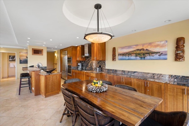 tiled dining room featuring a raised ceiling