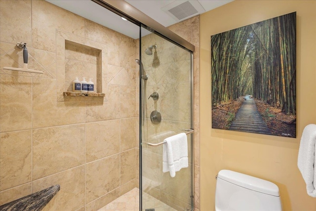 bathroom with an enclosed shower and toilet