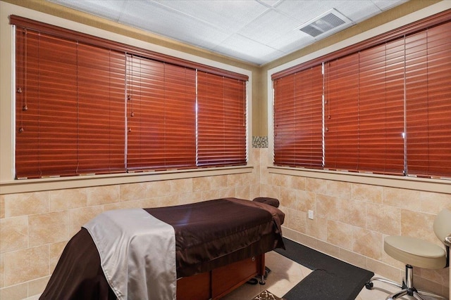 bedroom with tile walls