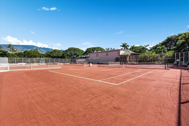 view of sport court featuring a mountain view and basketball hoop