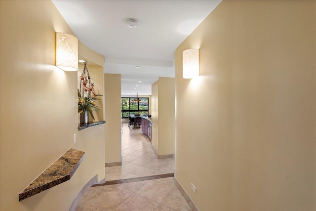 hall with light tile patterned floors