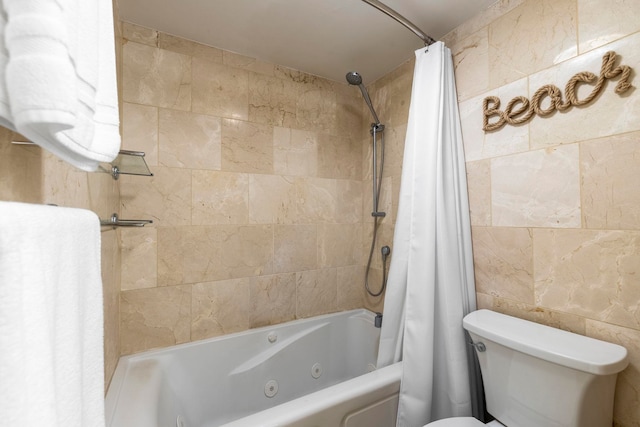 bathroom featuring shower / tub combo with curtain, tile walls, and toilet