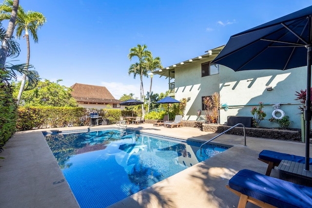 view of pool featuring a patio and a grill