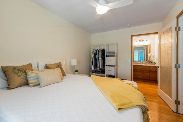 bedroom with ceiling fan, sink, a closet, ensuite bath, and light hardwood / wood-style floors