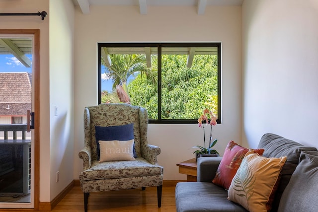 sitting room featuring hardwood / wood-style flooring and beamed ceiling