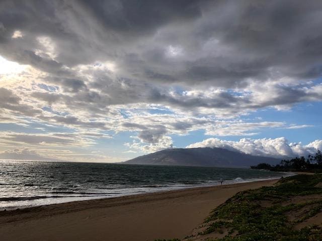 property view of mountains with a water view and a beach view