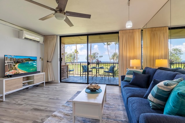 living room featuring expansive windows, a wall mounted air conditioner, wood finished floors, and ceiling fan