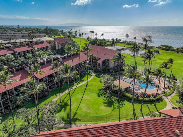 drone / aerial view with golf course view and a water view