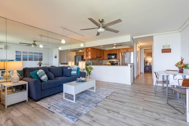 living room with track lighting, light wood-style floors, and ceiling fan