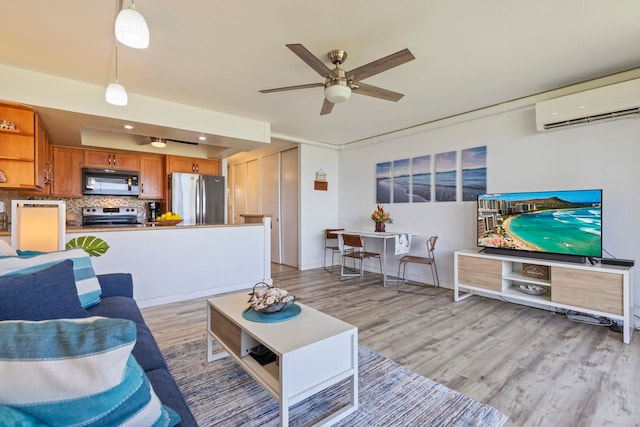 living room featuring recessed lighting, a ceiling fan, a wall mounted AC, and light wood-style floors