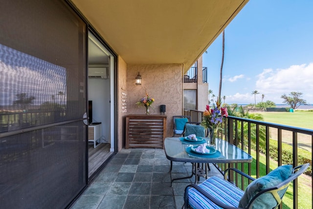 balcony featuring an AC wall unit