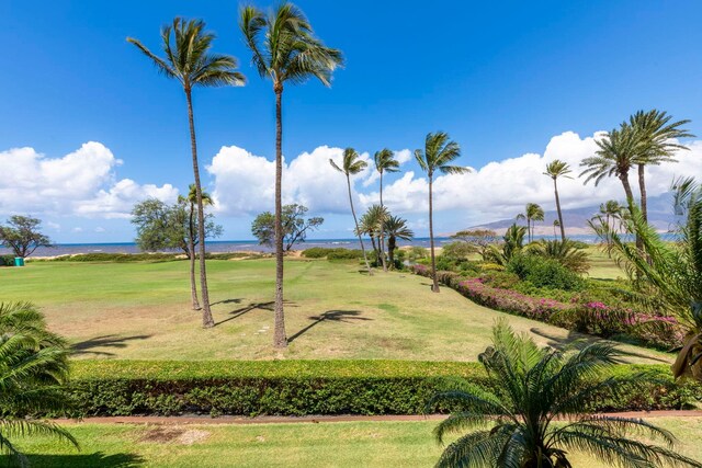 view of property's community featuring a yard and a water view
