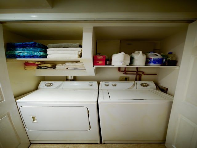 laundry area with independent washer and dryer