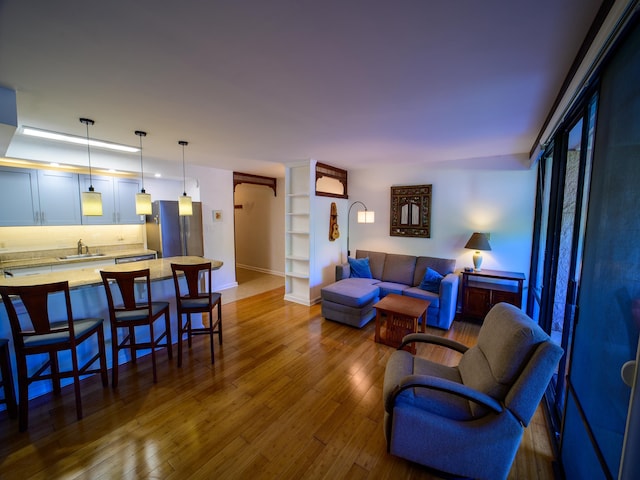 living room featuring wood-type flooring and sink