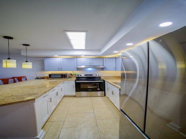 kitchen featuring light stone countertops, white cabinetry, pendant lighting, light tile patterned flooring, and appliances with stainless steel finishes