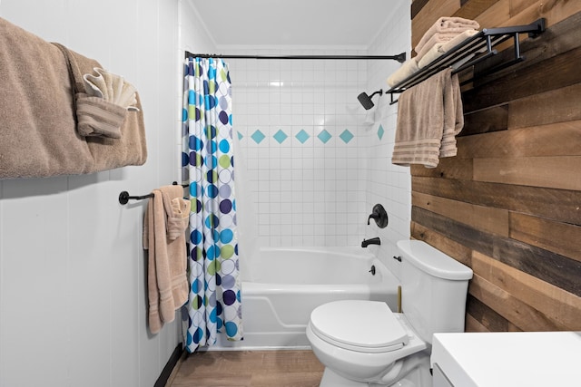 bathroom featuring shower / bathtub combination with curtain, ornamental molding, toilet, and hardwood / wood-style floors