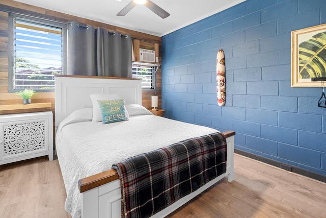 bedroom with multiple windows, ceiling fan, and light wood-type flooring