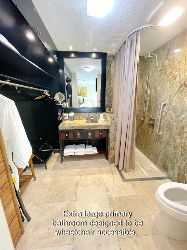 bathroom with vanity, curtained shower, a textured ceiling, and tile walls