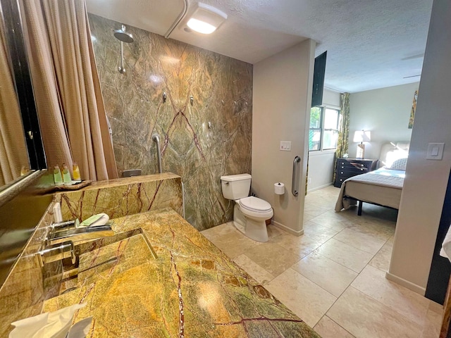 bathroom with toilet, a shower, a textured ceiling, and tile walls