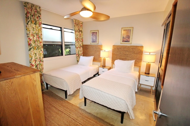 bedroom with ceiling fan and light tile patterned flooring