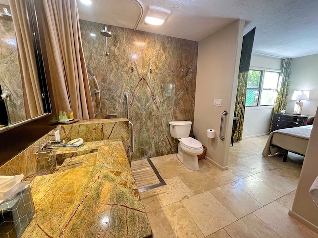 bathroom featuring a textured ceiling, toilet, walk in shower, and tile walls