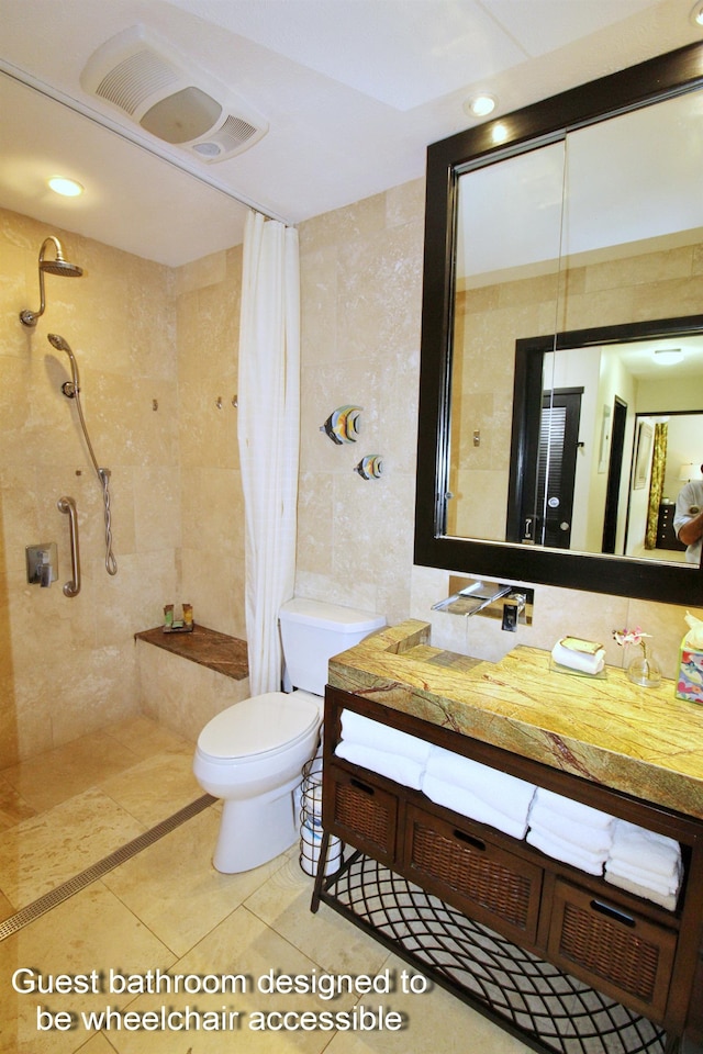 bathroom featuring tile patterned floors, a shower with curtain, vanity, tile walls, and toilet