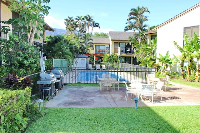 view of swimming pool featuring a patio area and a lawn