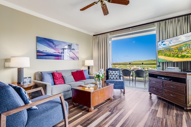 living room featuring ceiling fan, ornamental molding, and hardwood / wood-style flooring