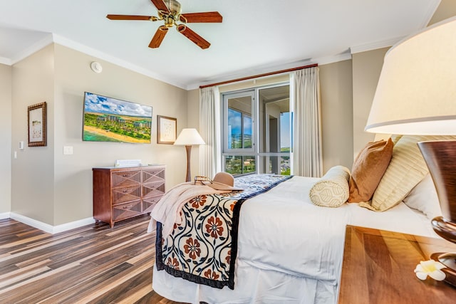 bedroom featuring dark hardwood / wood-style floors, ornamental molding, and ceiling fan