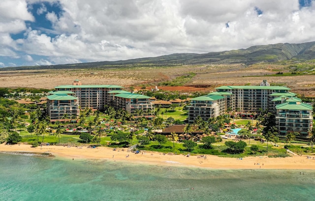 drone / aerial view with a view of the beach and a water and mountain view