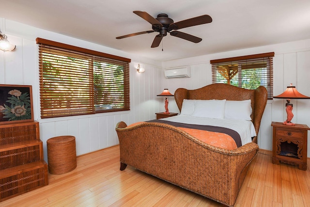 679 Kaapuni Pl, Kihei, HI 96753 - bedroom with a wall unit AC, multiple windows, wood finished floors, and a decorative wall