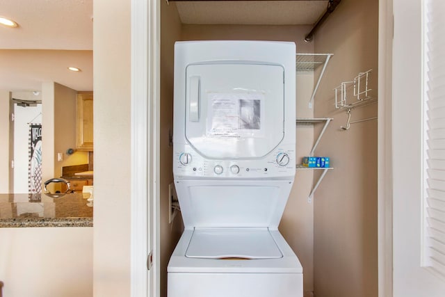 laundry room featuring stacked washer and dryer