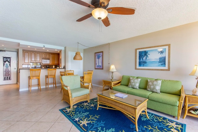 tiled living room featuring ceiling fan and a textured ceiling