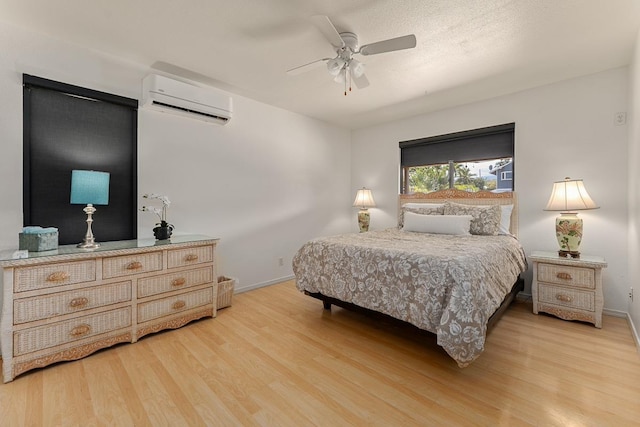 2730 Ohina St, Kihei, HI 96753 - bedroom with a wall unit AC, wood finished floors, baseboards, and ceiling fan