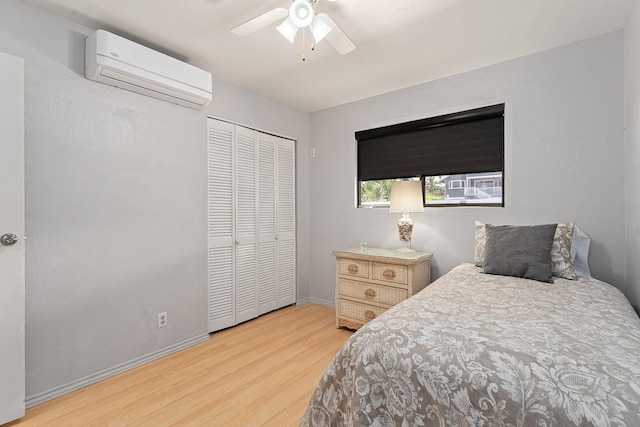 2730 Ohina St, Kihei, HI 96753 - bedroom featuring an AC wall unit, wood finished floors, baseboards, a closet, and ceiling fan