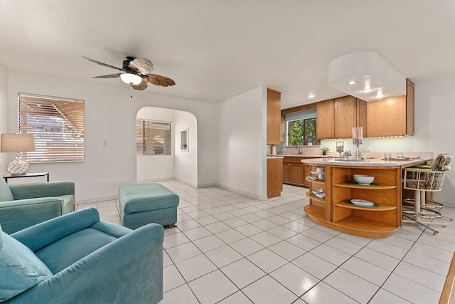 2730 Ohina St, Kihei, HI 96753 - living area with a ceiling fan, arched walkways, light tile patterned flooring, recessed lighting, and baseboards