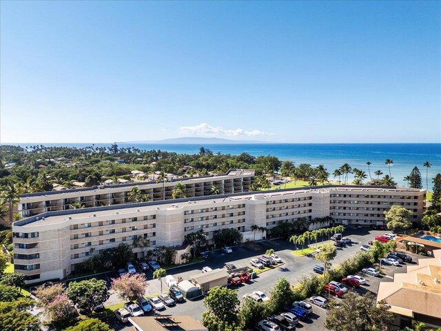 drone / aerial view of apartment complex / building and a nearby body of water