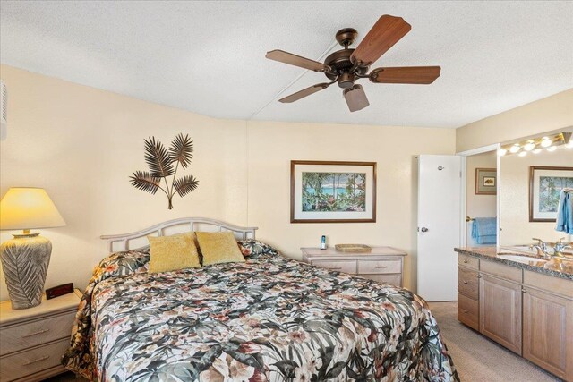 bedroom with light carpet, a sink, and ceiling fan