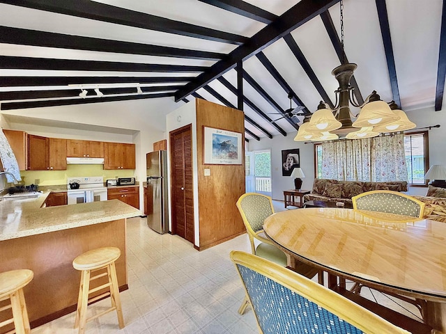 kitchen with electric stove, sink, stainless steel refrigerator, lofted ceiling with beams, and kitchen peninsula