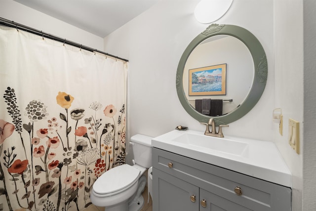 bathroom featuring walk in shower, vanity, and toilet