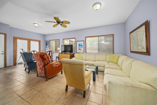 tiled living room featuring ceiling fan and a healthy amount of sunlight