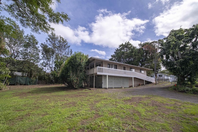 exterior space featuring a lawn and a sunroom