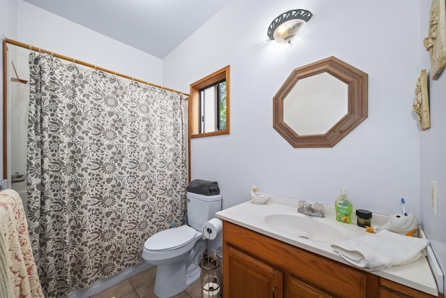 bathroom featuring vanity, tile patterned floors, and toilet